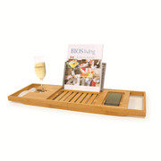Bamboo Bathtub Caddy with a magazine and glass of champagne